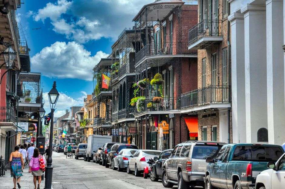 A historic New Orleans street scene with old buildings and live music culture