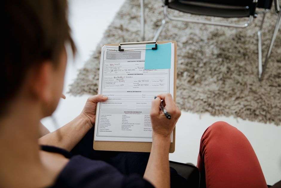 A stack of printed survey documents resting on an office desk