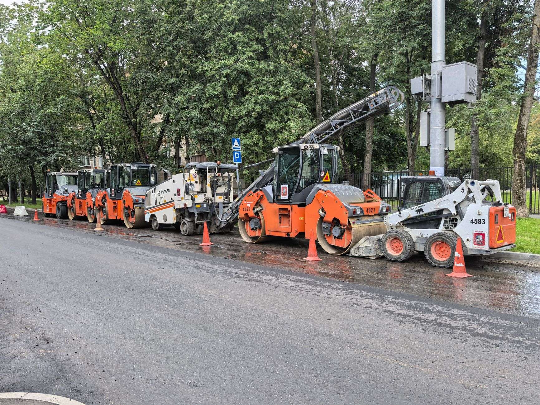 Orange traffic cones marking a road repair zone on a city street