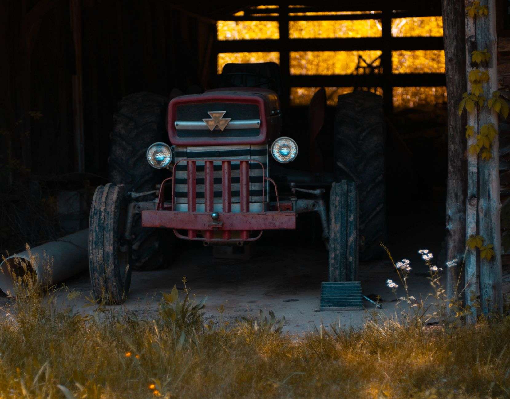 A restored vintage farm tractor on display at an outdoor event
