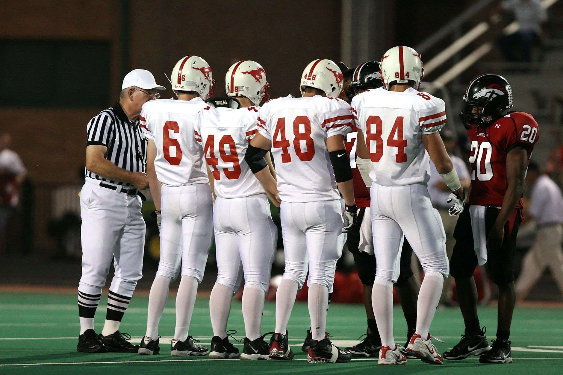 High school football players in action during a game