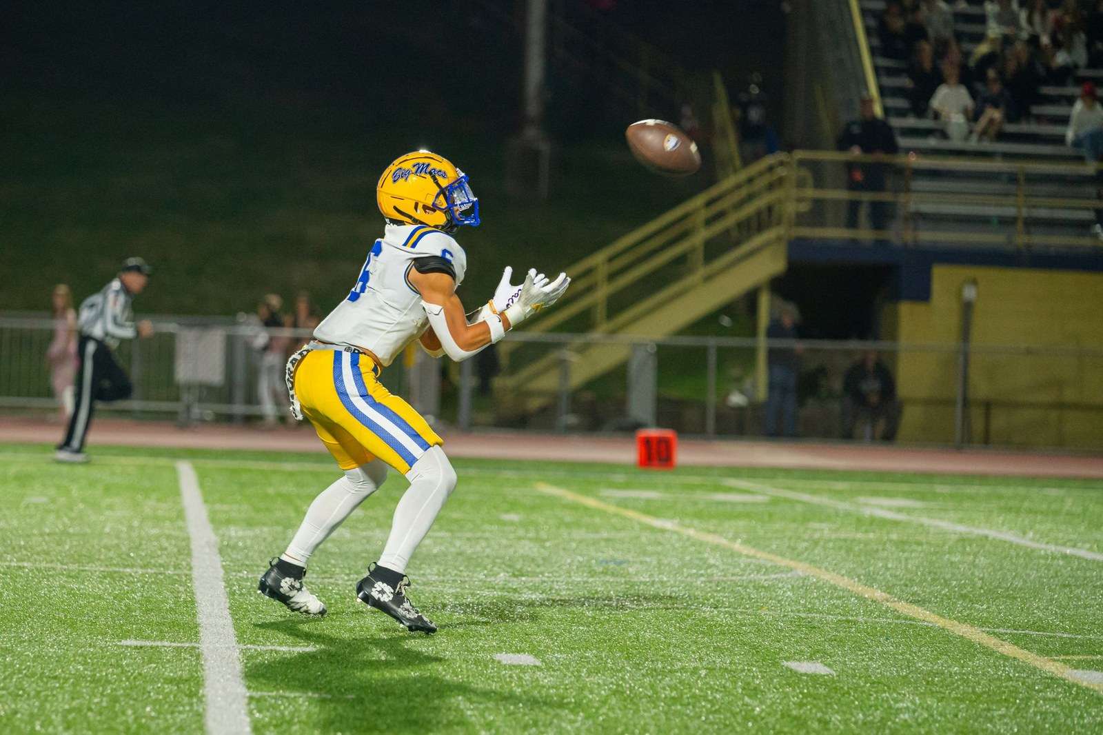 A football receiver catching a pass during a game