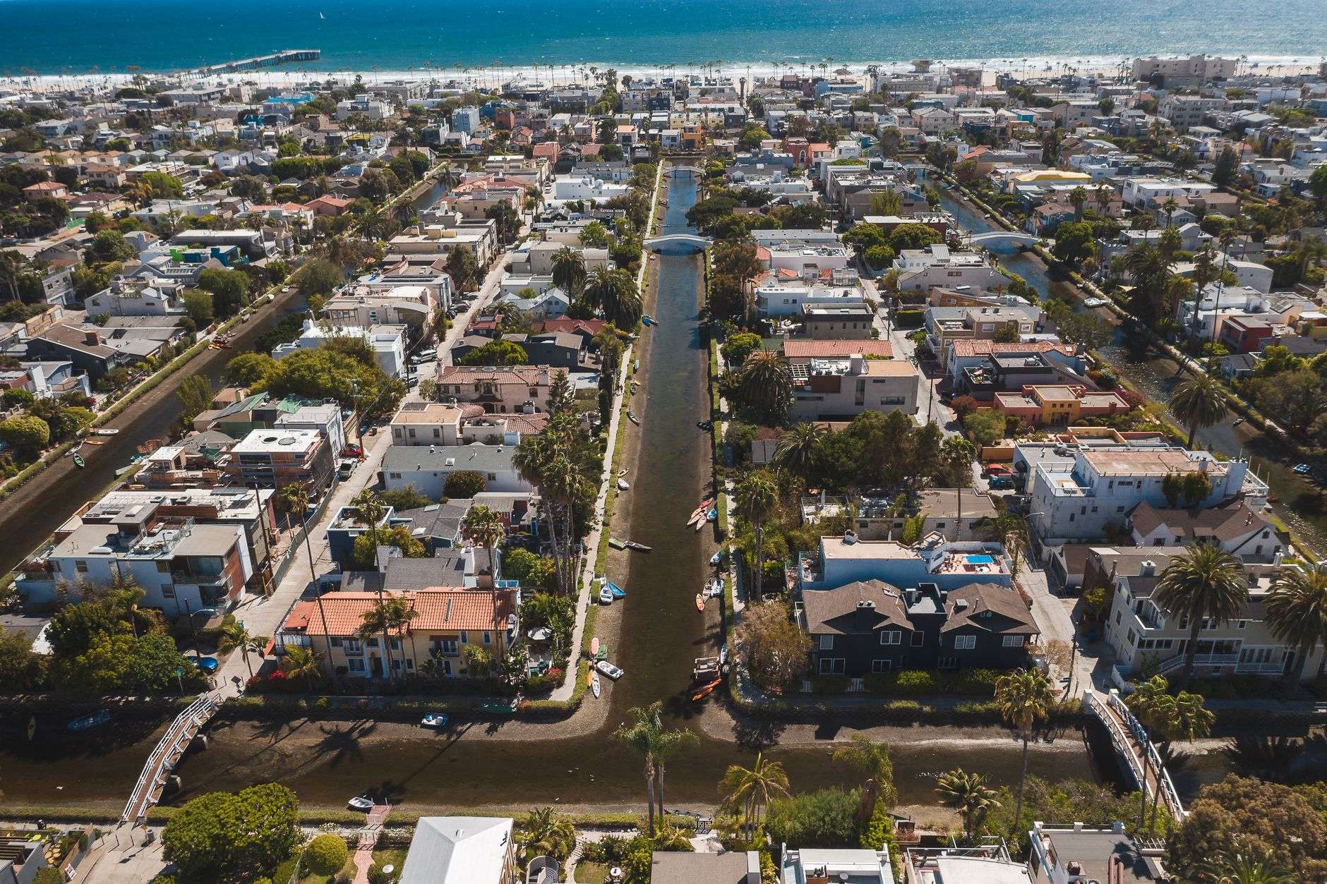 Drainage canal running alongside a coastal residential area