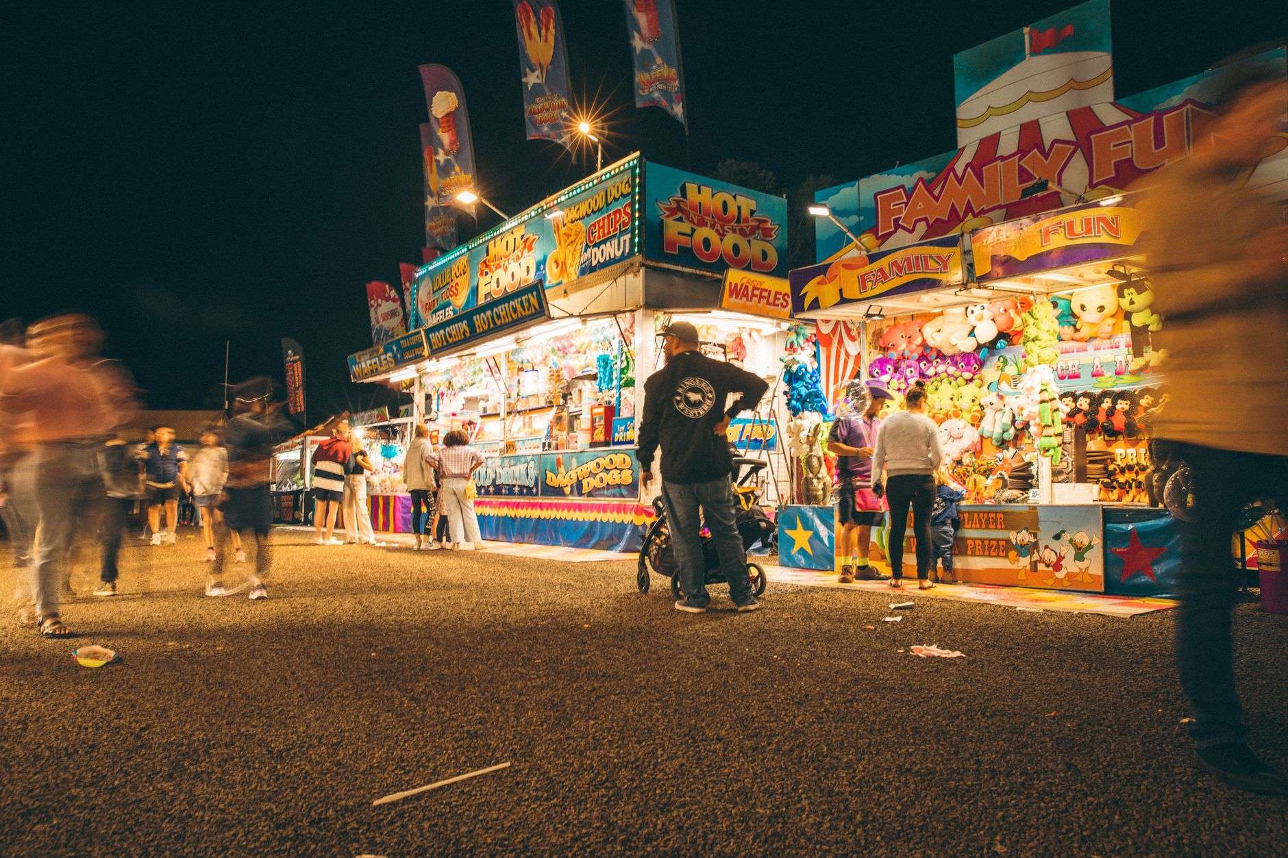 Vendor booths and visitors at an outdoor fall festival