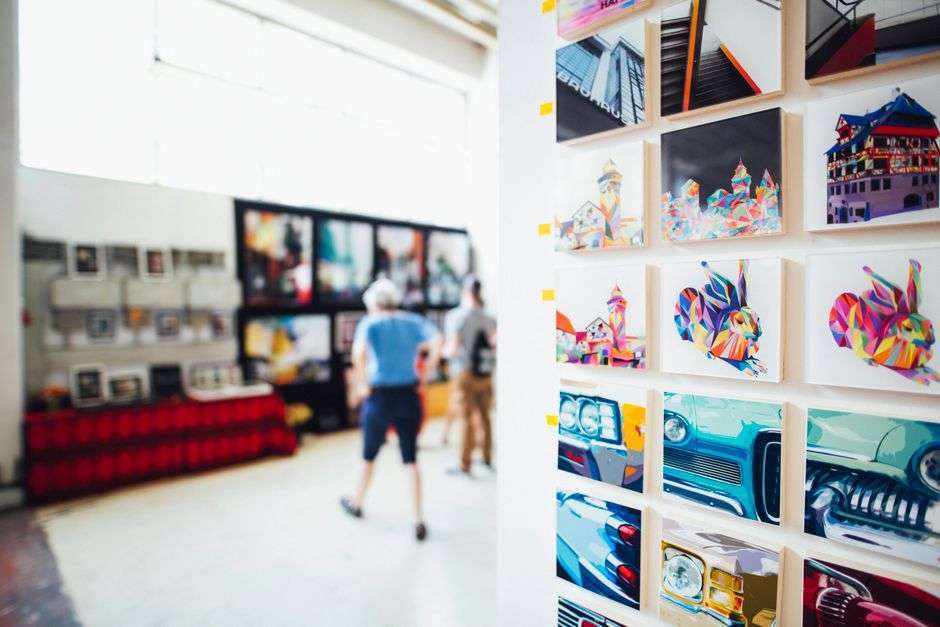 Framed paintings hanging on a wall in an art gallery exhibition