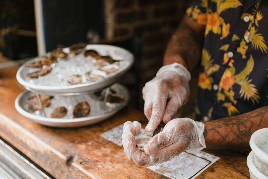 Oysters on ice at a restaurant raw bar counter