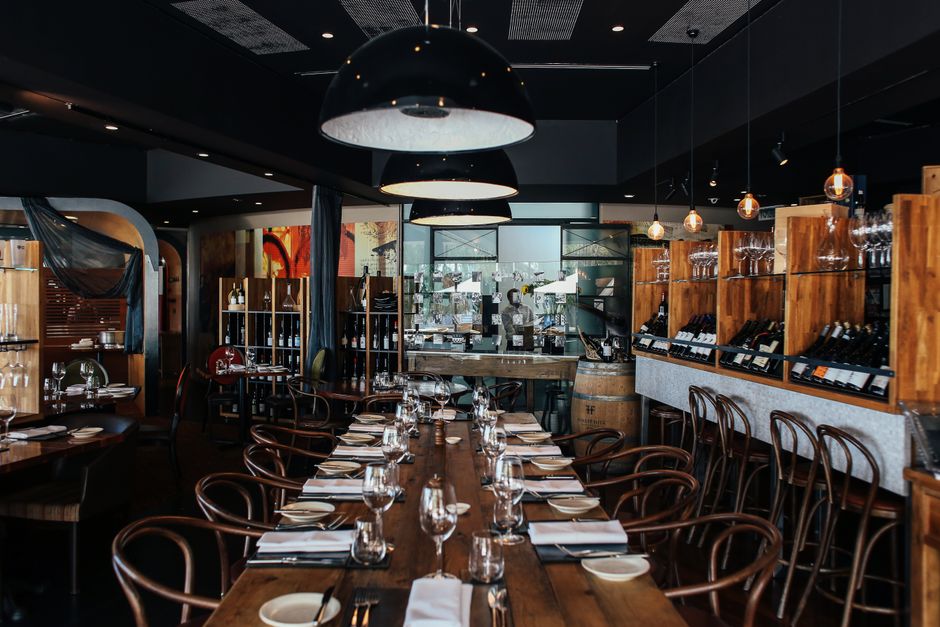 A cozy bistro dining room set with tables and warm lighting