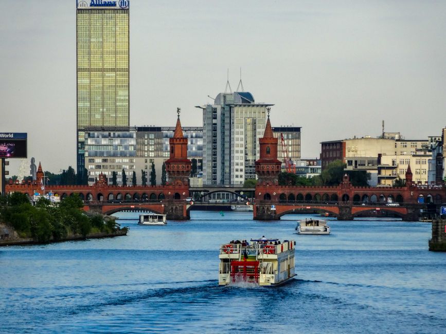 Riverboat cruising on a river past a city skyline