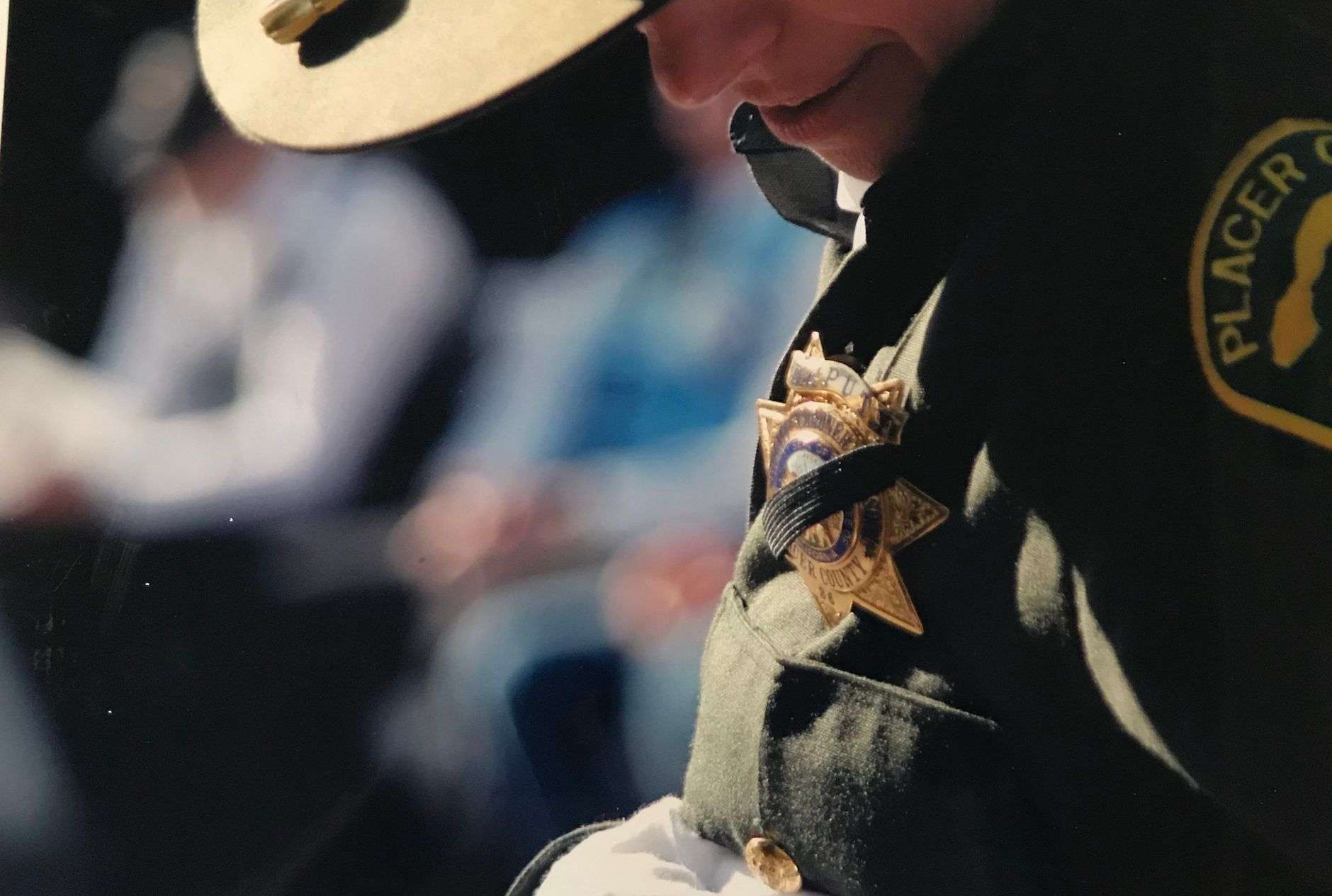 A police badge and uniform, illustrating the swearing-in of a new municipal police chief