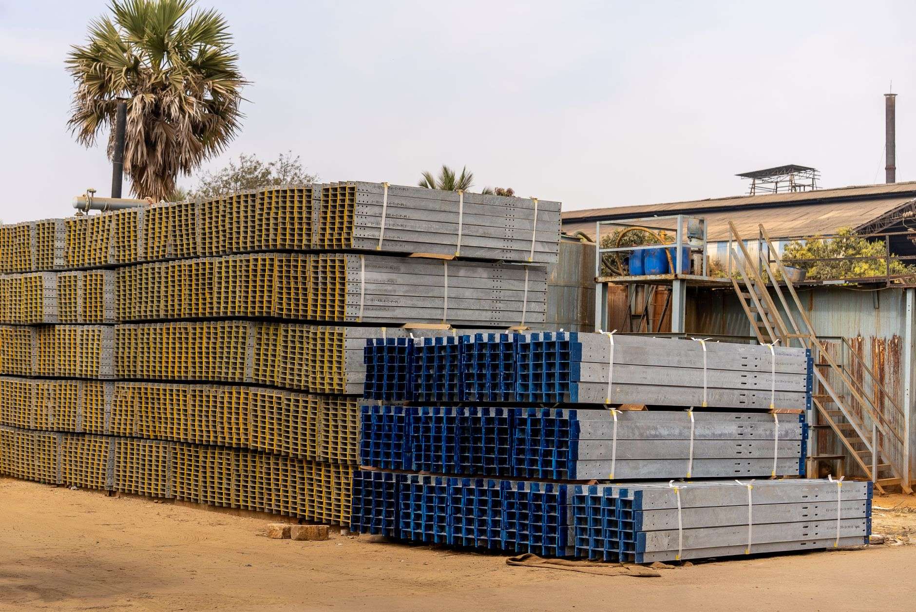 Stacked steel plate and structural steel inside an industrial processing facility