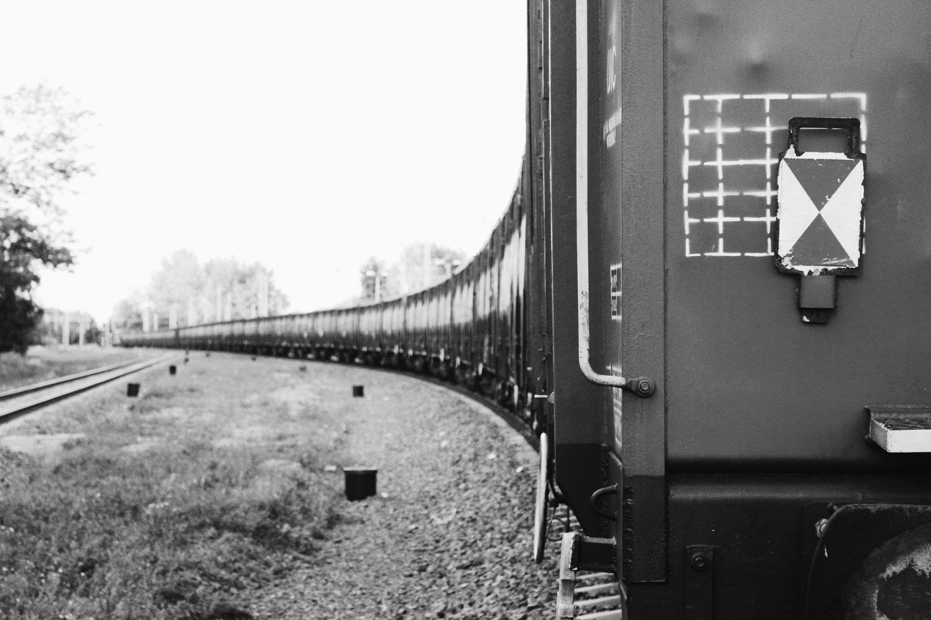 A freight train rounding a bend on railroad track, illustrating a rail line curve