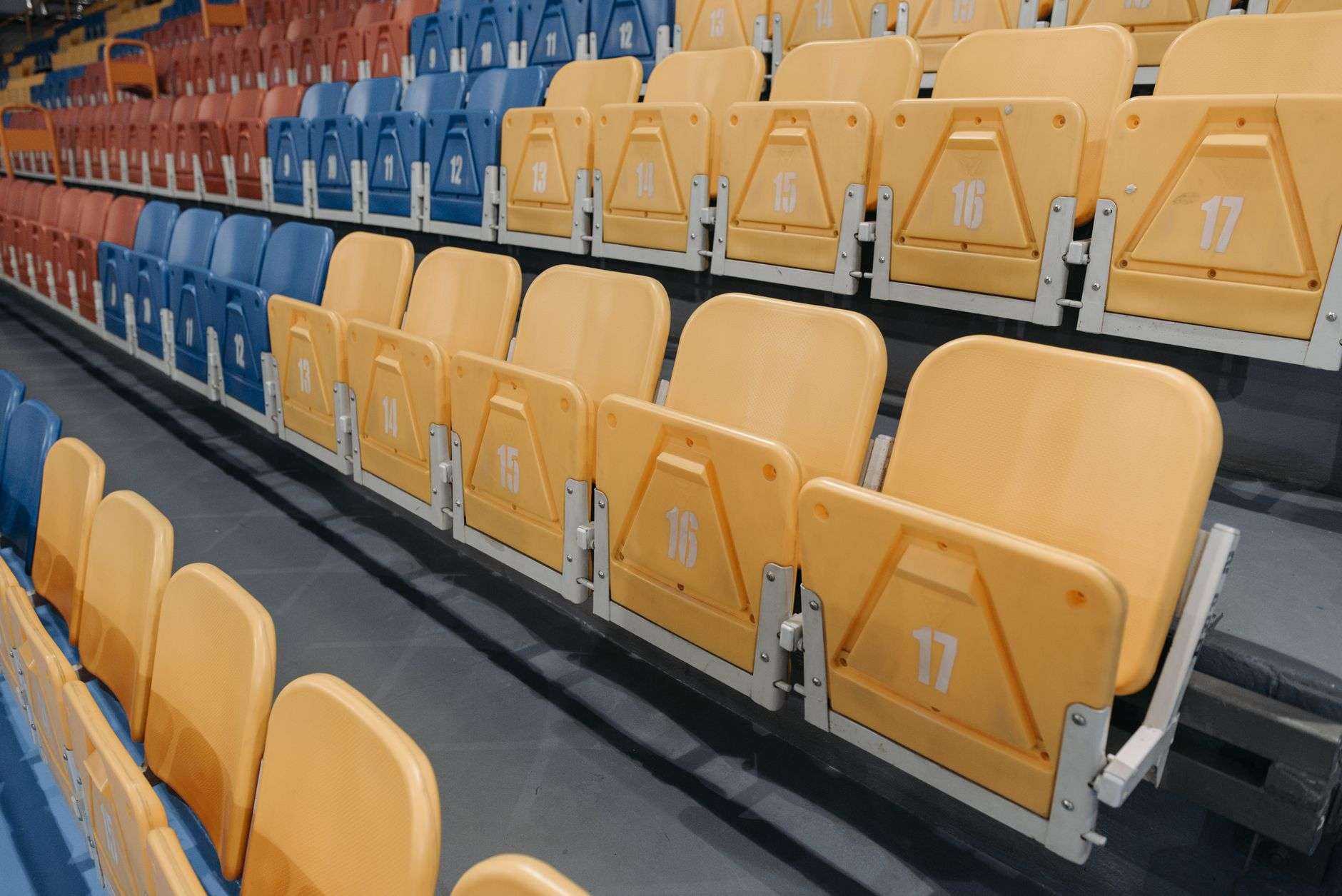 Rows of empty seats in a modern indoor arena bowl before an event