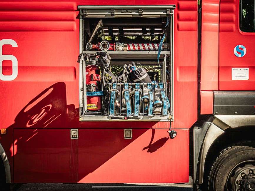 Firefighters standing near a fire truck at a station