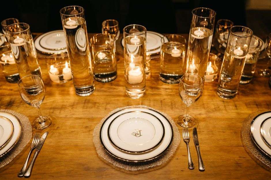 An elegant dinner table set with antique china and candlelight in a cozy dining room