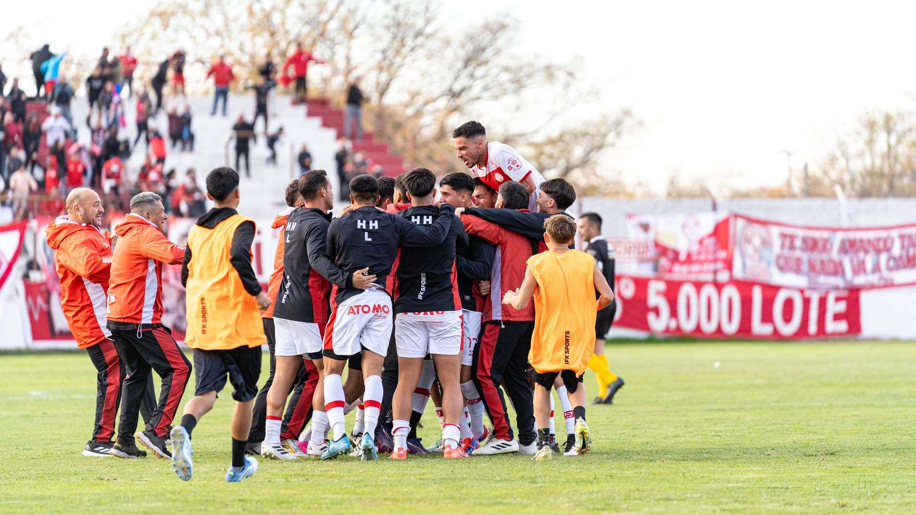 A football team celebrating together after a victory