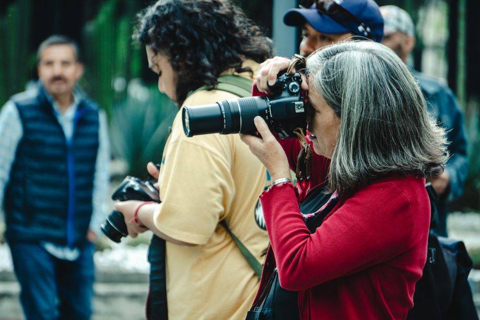 Photographer holding a camera while working at a community gathering