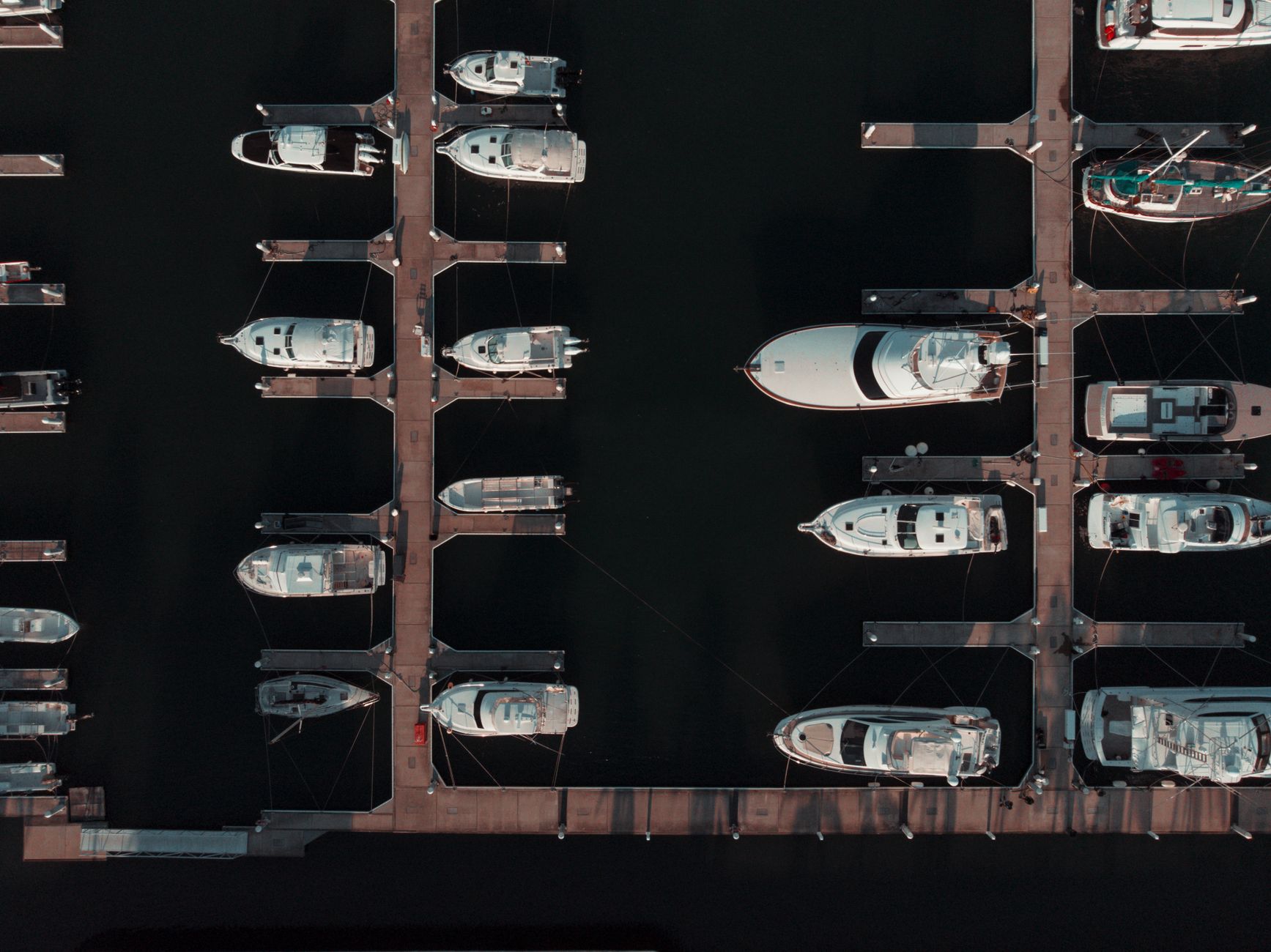 Rows of new fishing and pleasure boats displayed indoors at a boat show