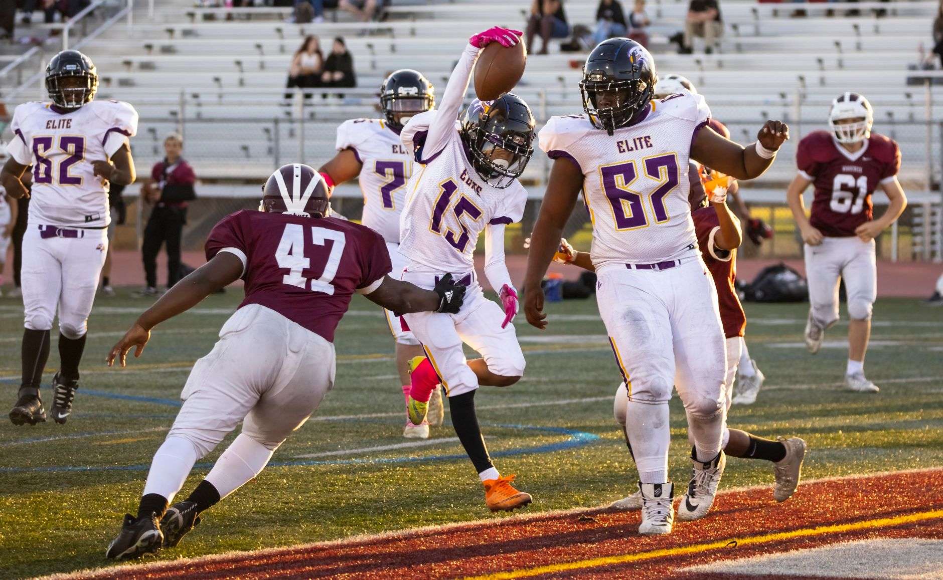 A football player in a helmet and pads on a field