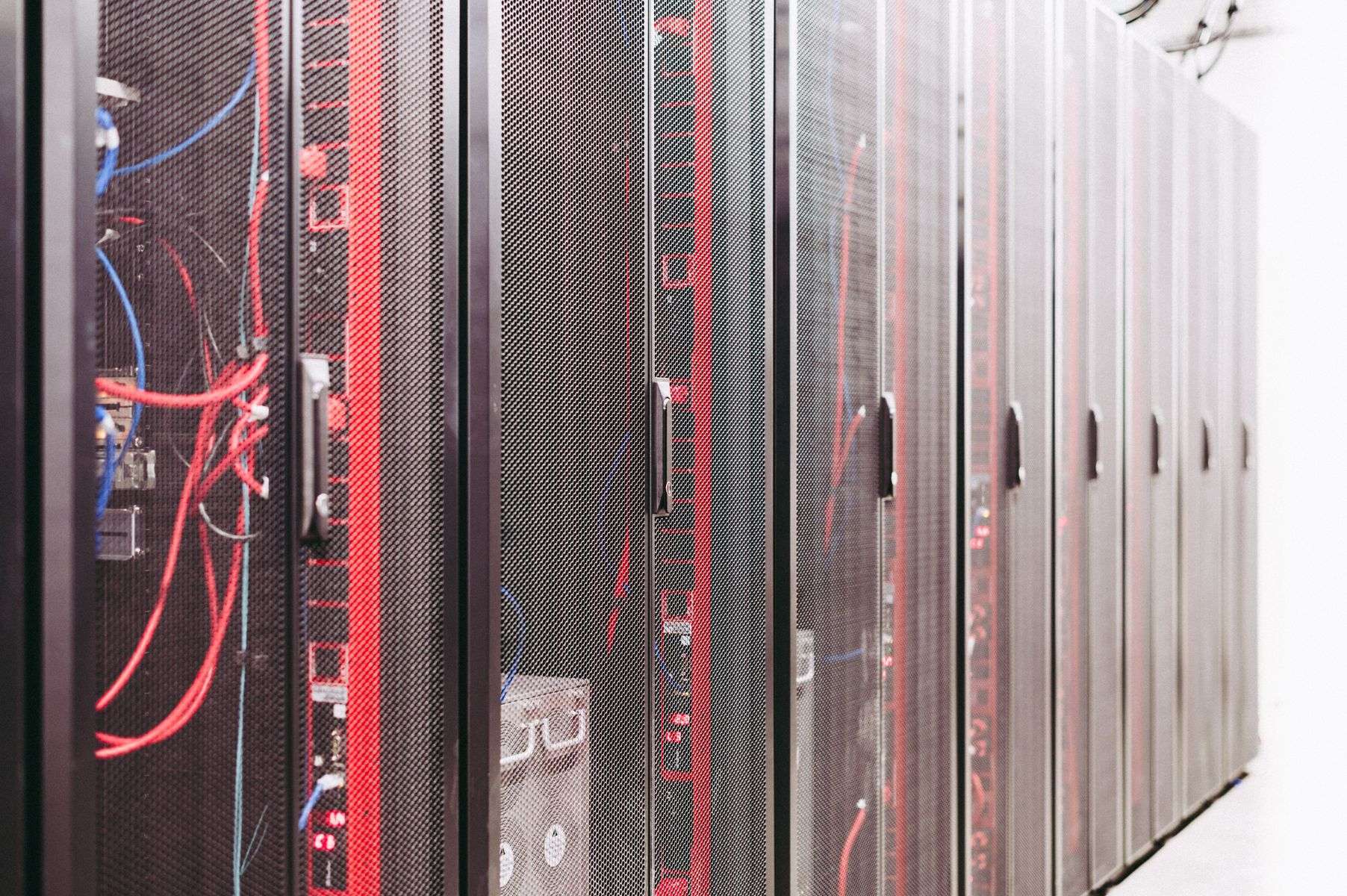 Row of server cabinets with cables in a data center