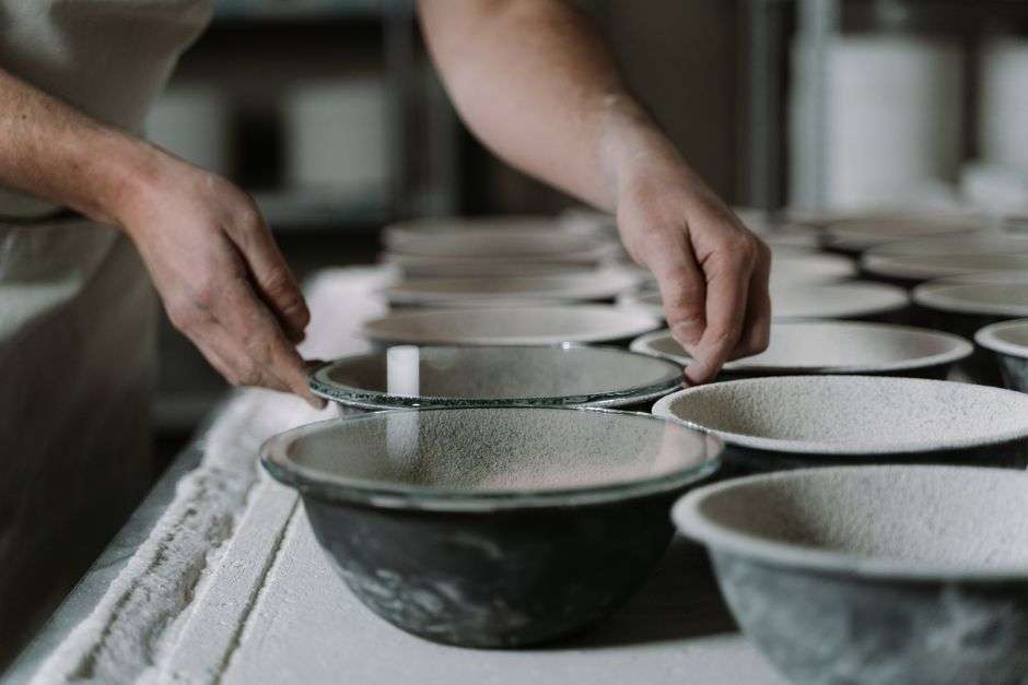 A handmade ceramic bowl crafted by a local potter on a wooden table