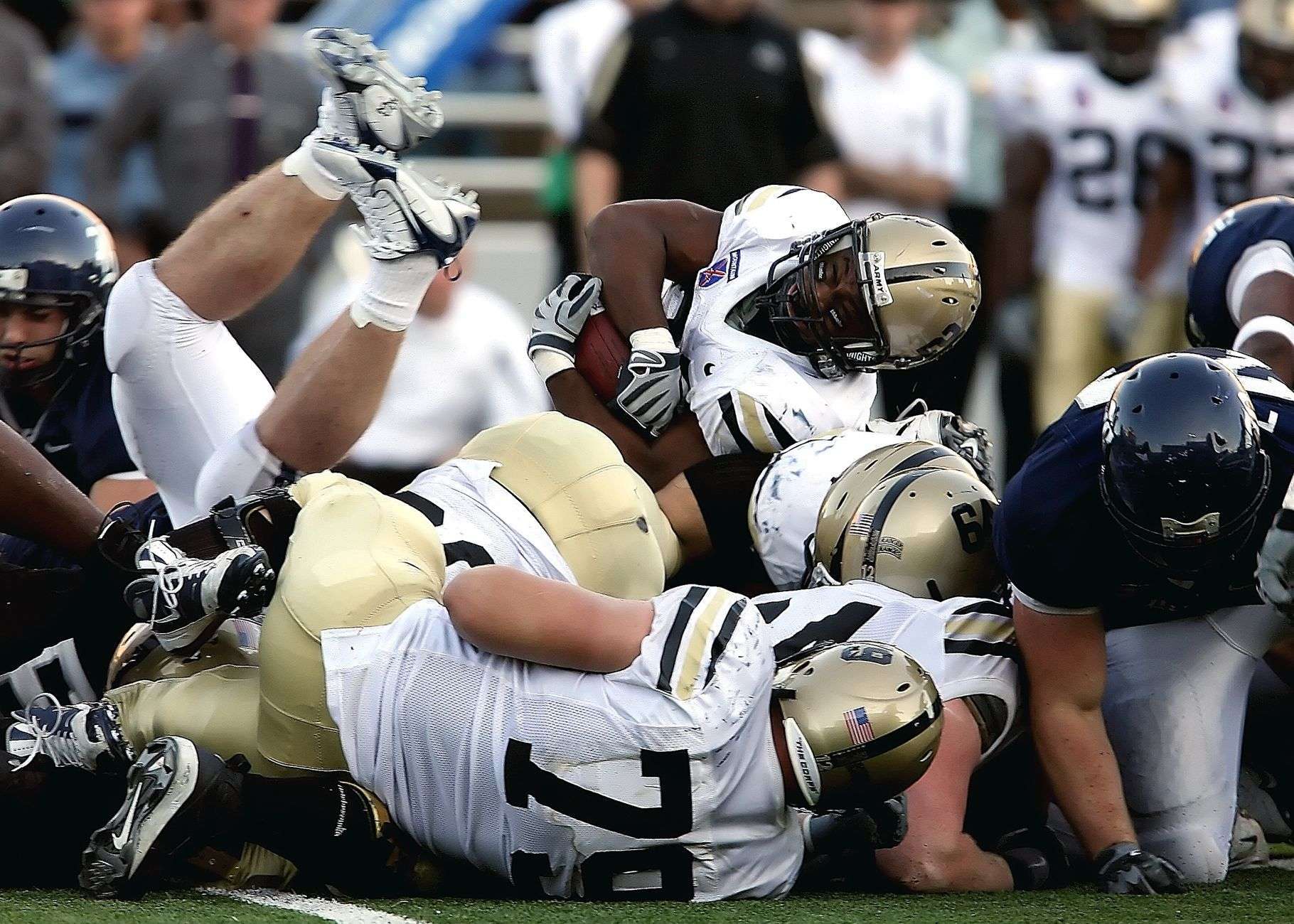 College football players in action during a stadium game