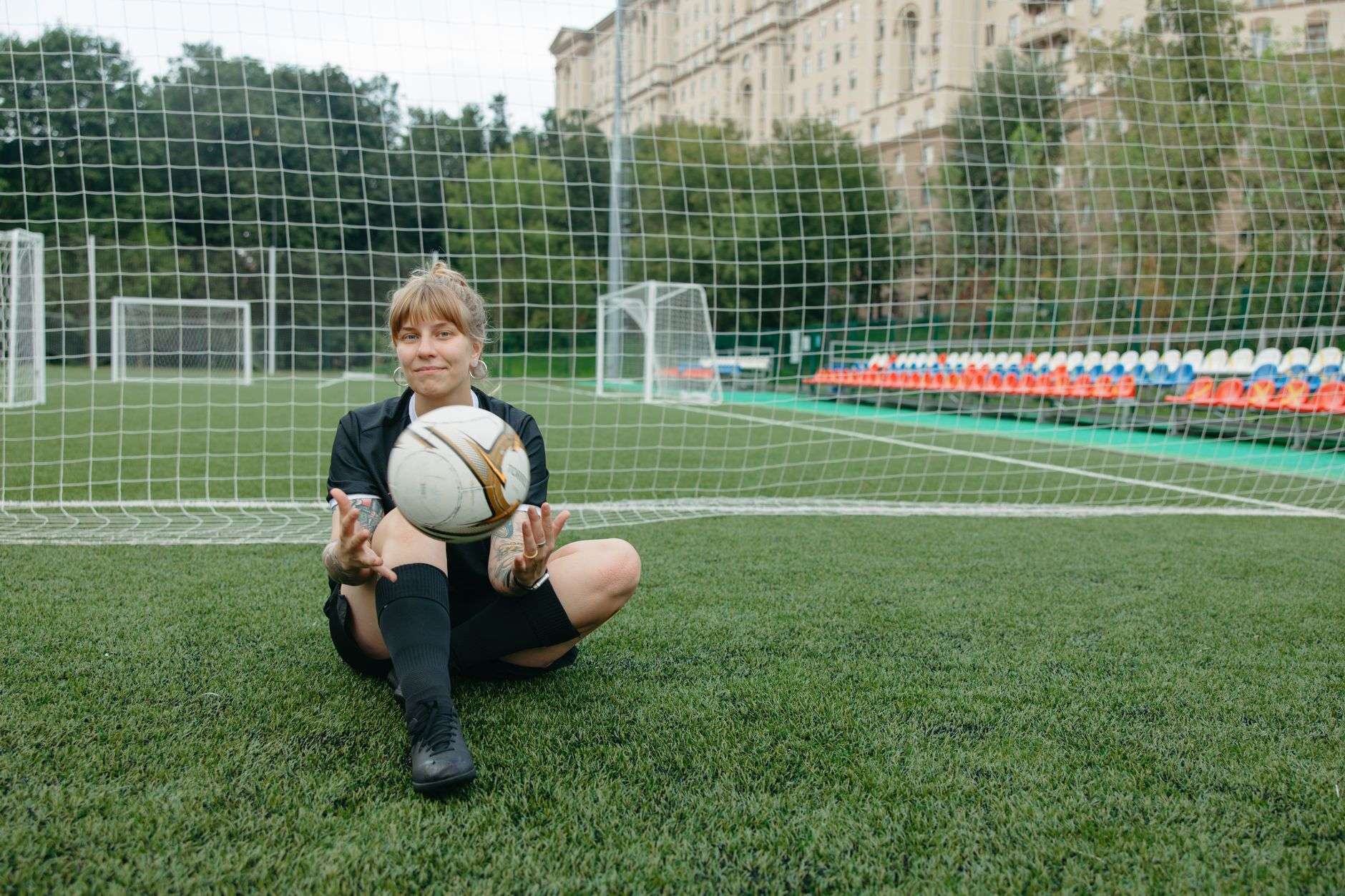 Soccer ball on a pitch in front of a goal