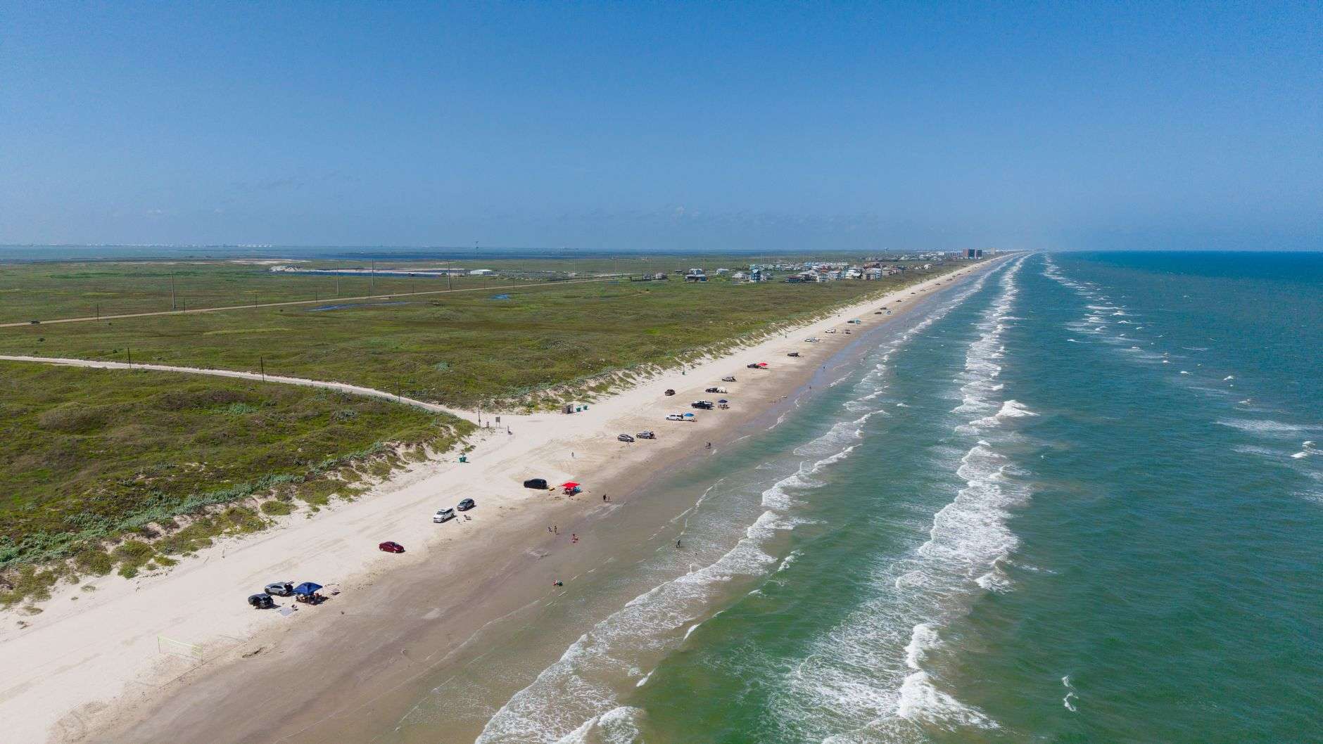 Sunny sky over a Gulf Coast beach with gentle surf
