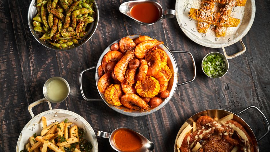 A plate of fried shrimp and Cajun sides at a small restaurant