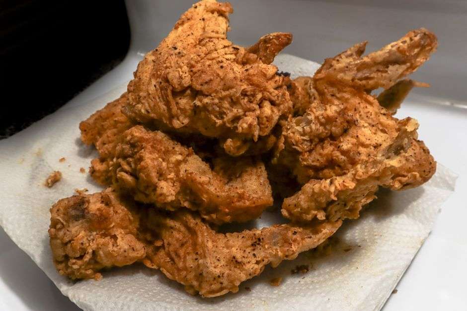 A plate of Southern country food with fried chicken and vegetable sides