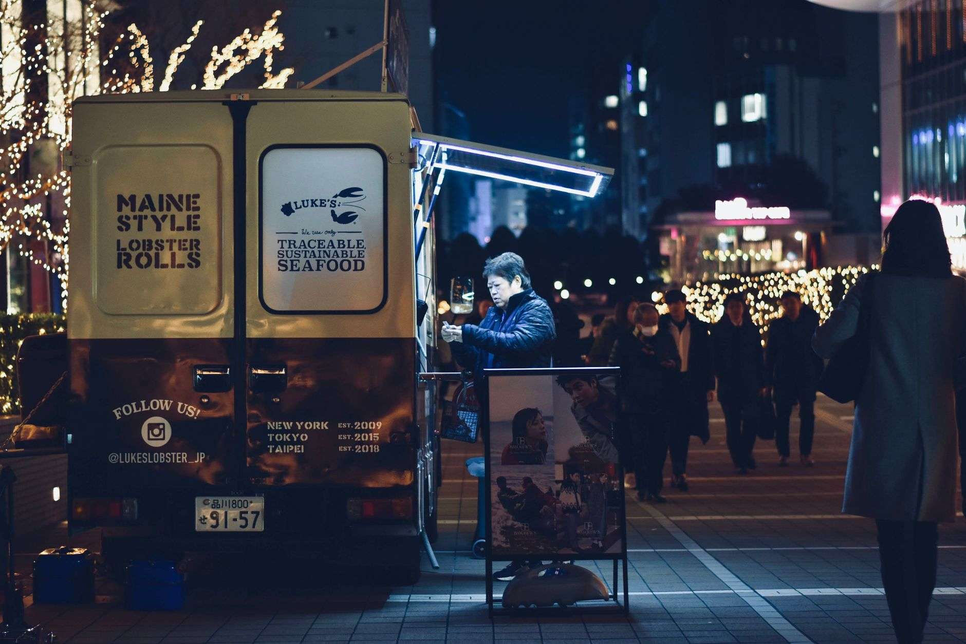 Food truck serving customers in an outdoor parking area