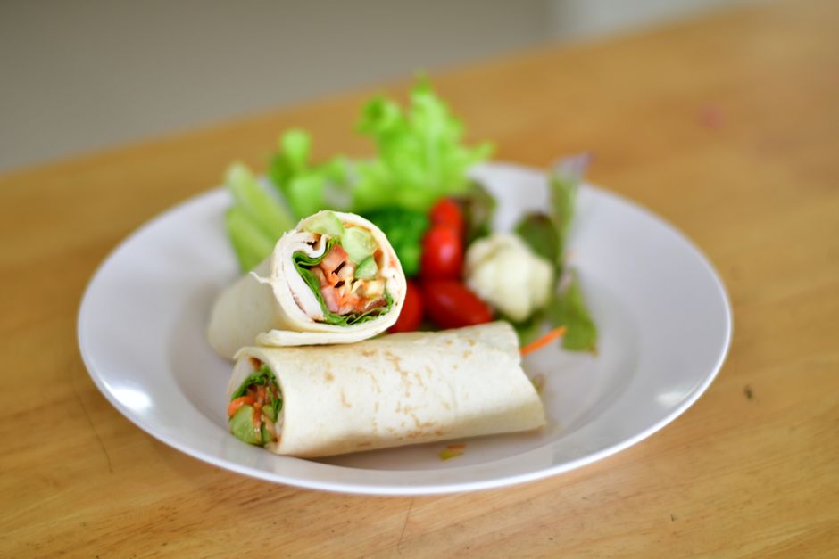 Fresh wraps and healthy lunch plates prepared at a small cafe counter