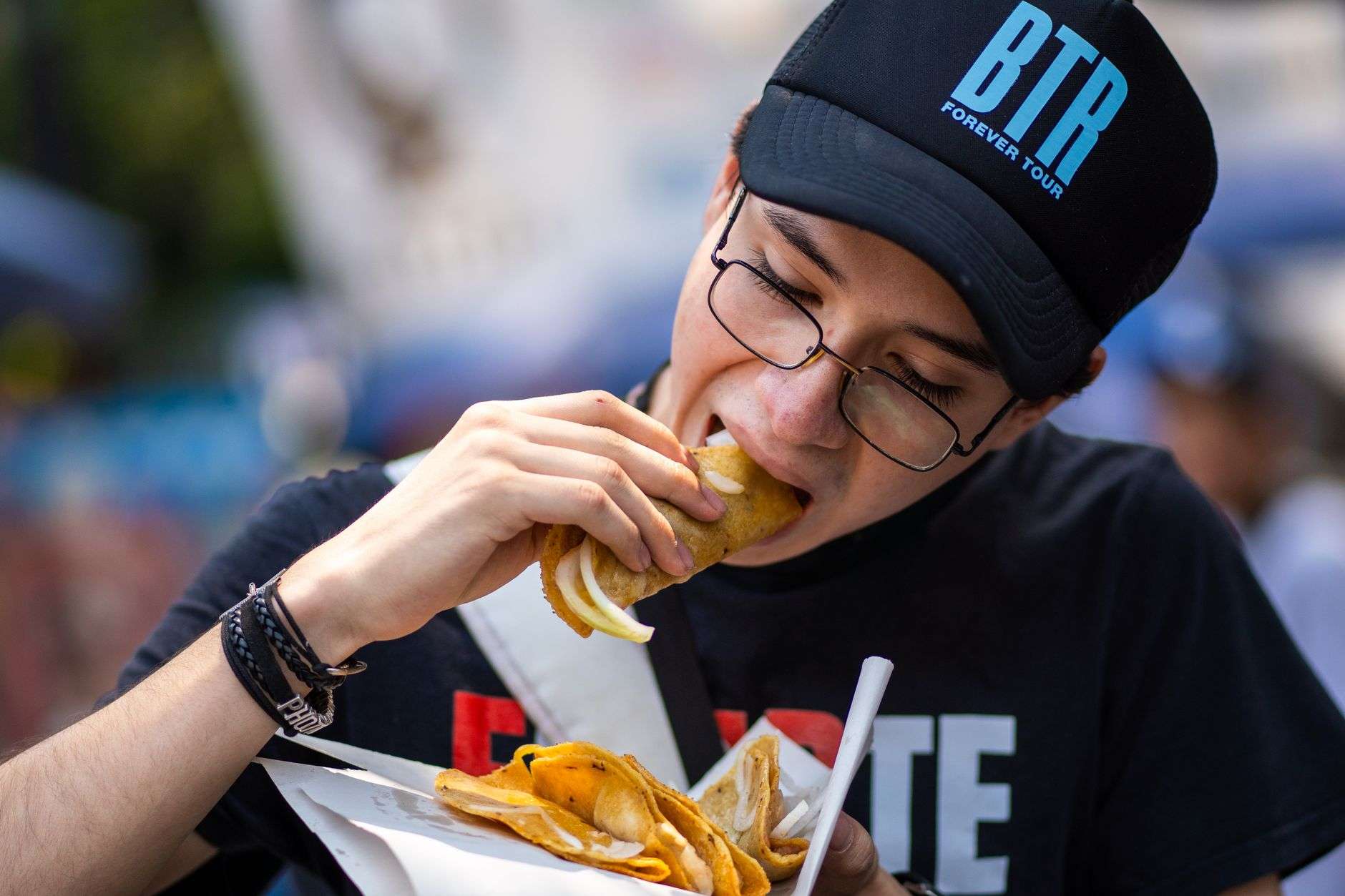 A plate of street tacos served at an outdoor festival