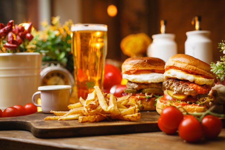 Sports bar interior with televisions, jerseys and a burger plate on a table