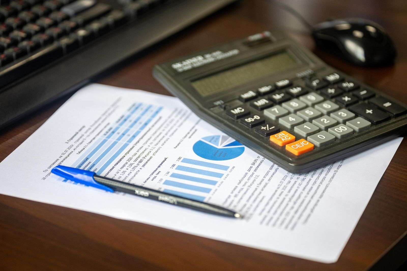 Financial documents and a calculator on a desk