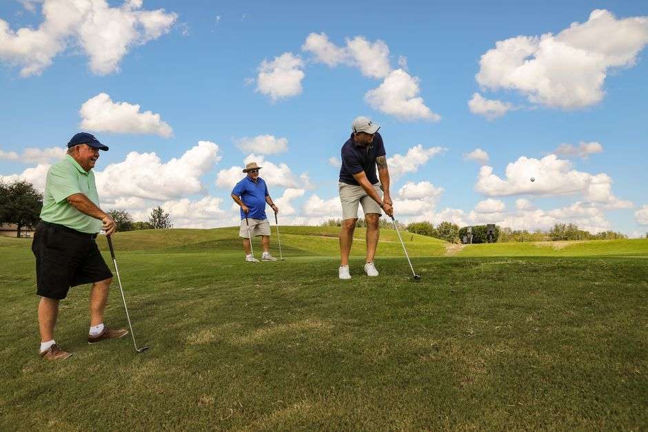 Golfers playing a round at a charity golf tournament on a sunny day