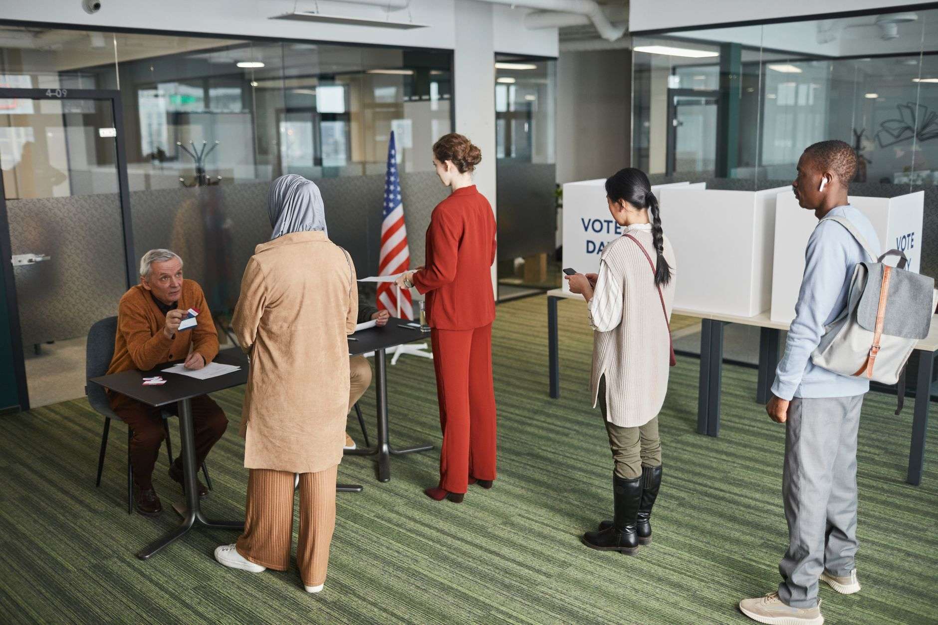 A voter registration table set up with forms and signage