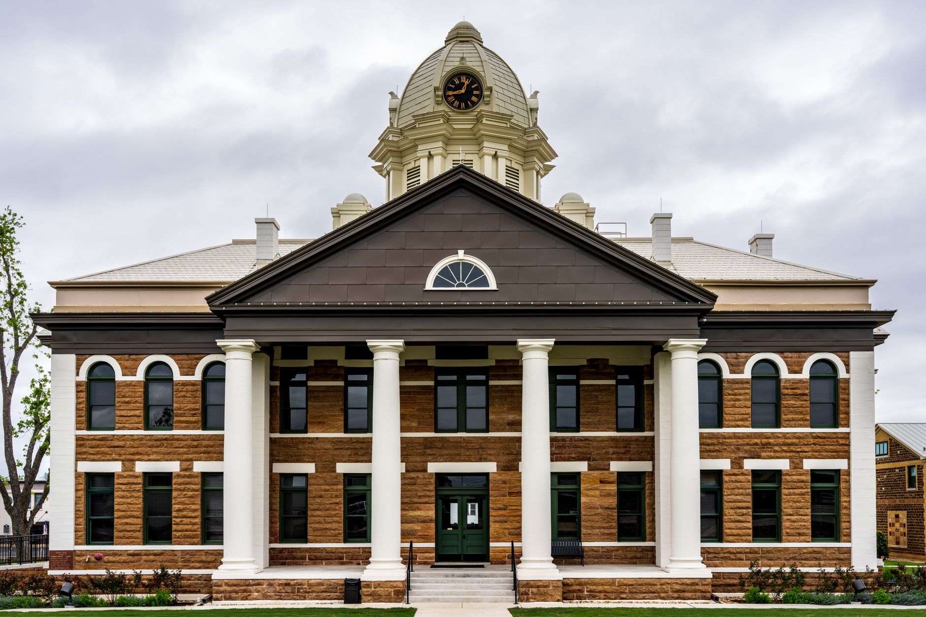 Exterior of a county courthouse with columns and steps under a clear sky