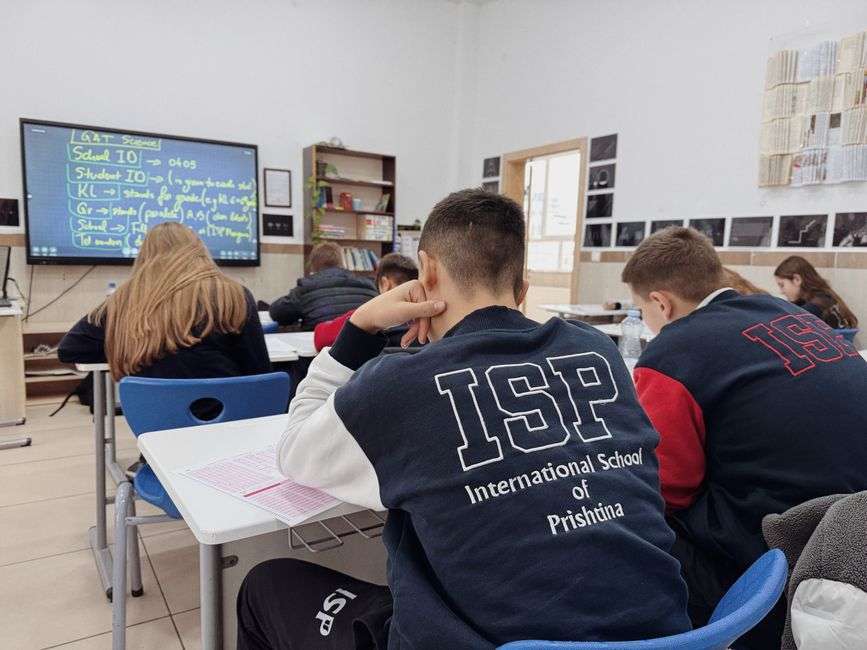 Empty high school classroom with rows of student desks and chairs