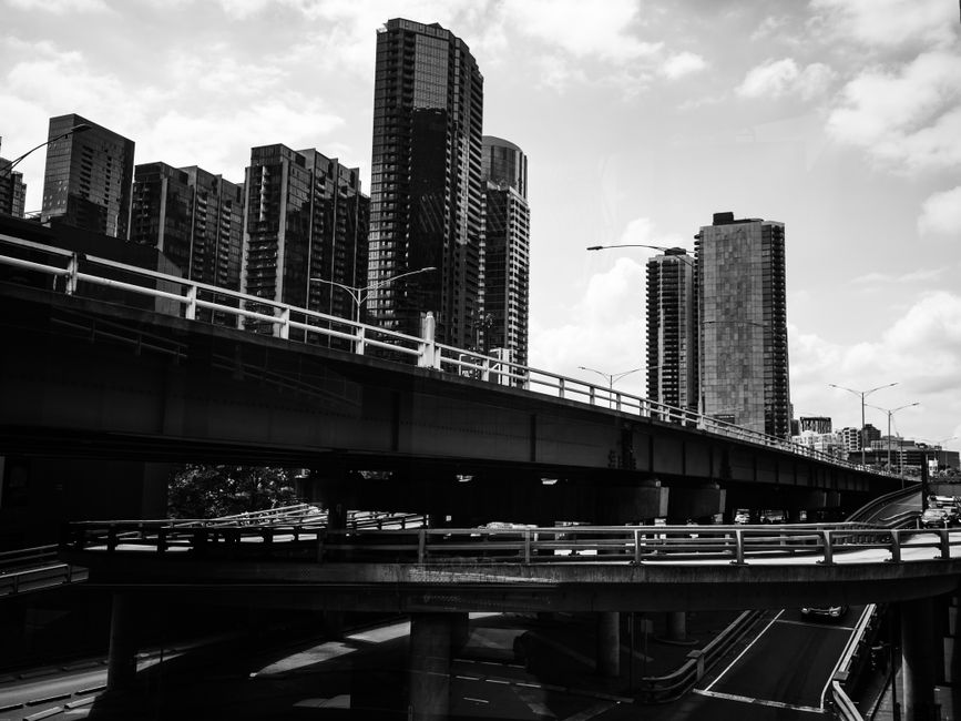 Highway overpass ramps crossing above a downtown city street