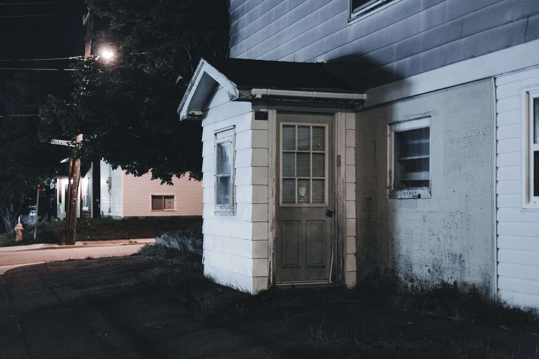 A single-family home at night with exterior lighting, illustrating a residential neighborhood where a shooting was reported