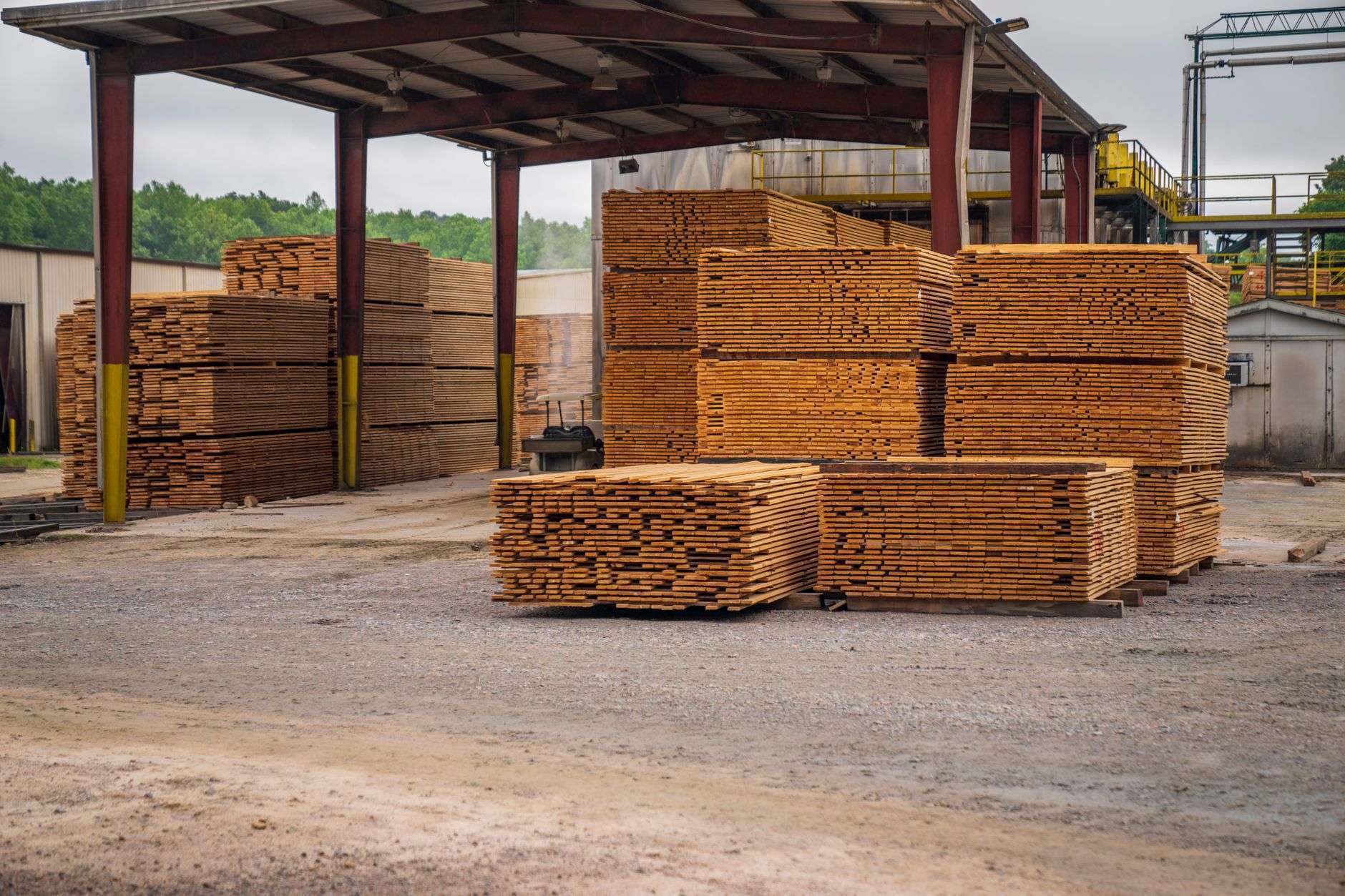 Stacks of pine lumber at a sawmill, illustrating Westervelt Lumber's Thomasville expansion