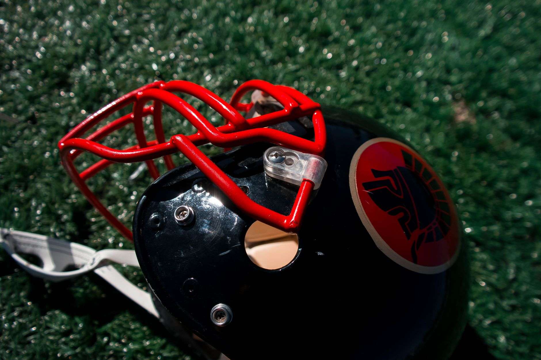 Football helmet resting on stadium turf