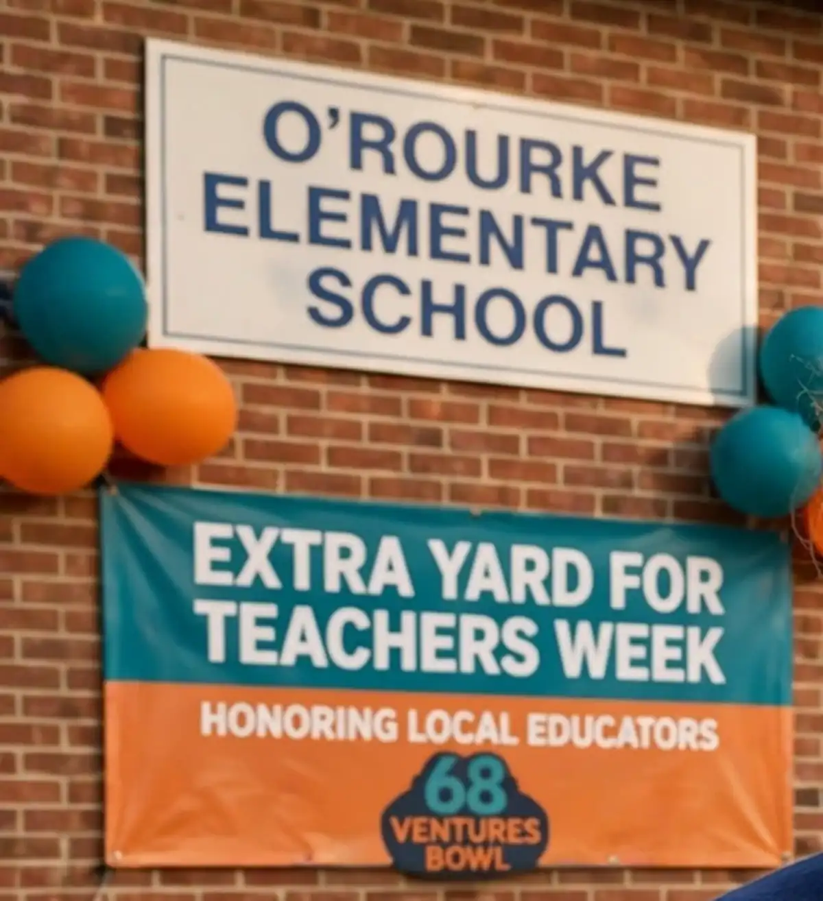 An elementary school sign on a brick wall above a banner reading Extra Yard for Teachers Week with balloons