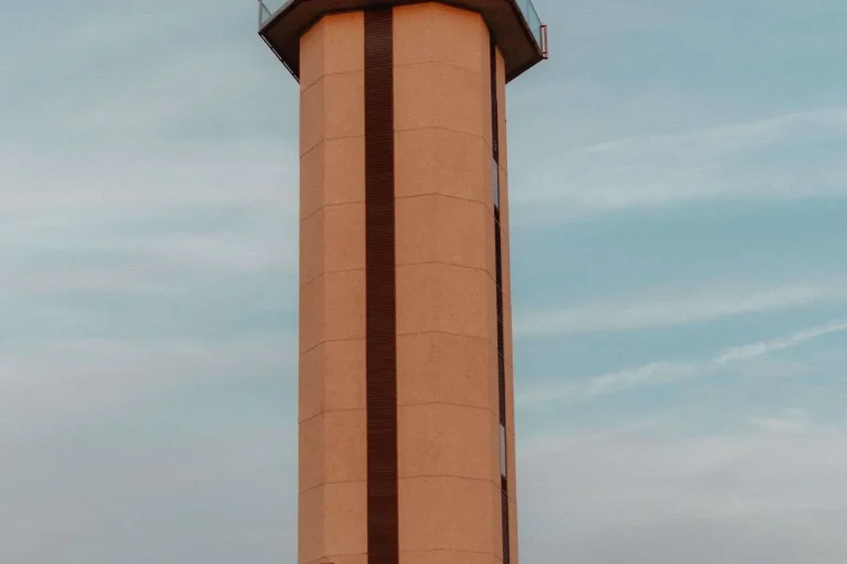 An airport control tower against a blue sky