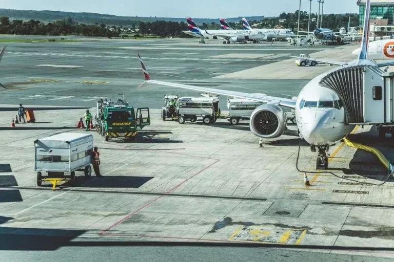 Ground crew preparing a passenger jet for departure on an airport tarmac