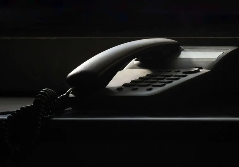 A telephone handset resting on an office desk