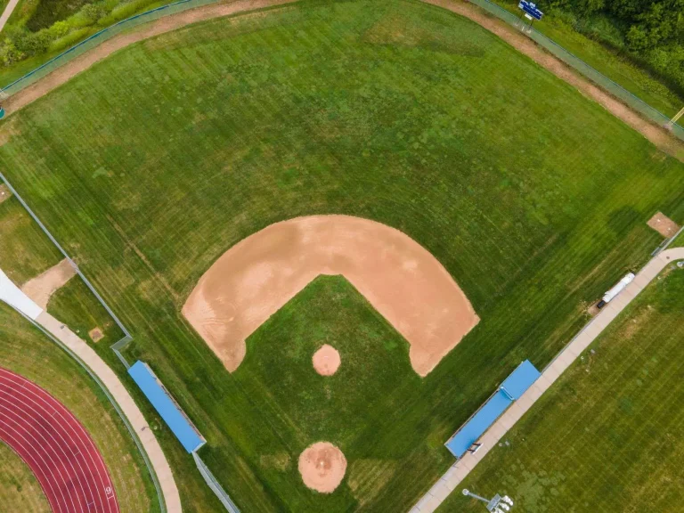 Aerial view of an empty grass baseball diamond with dirt infield and no visible team branding
