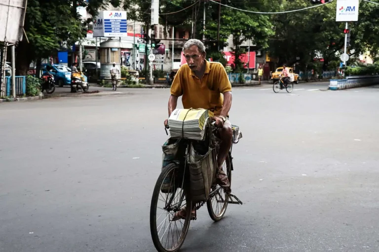 A bicycle with a newspaper bag at dawn
