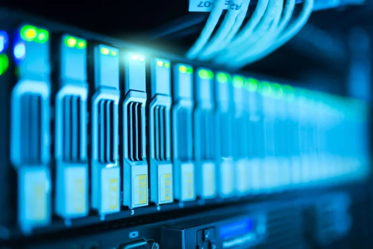 Rows of illuminated server racks inside a large data center facility