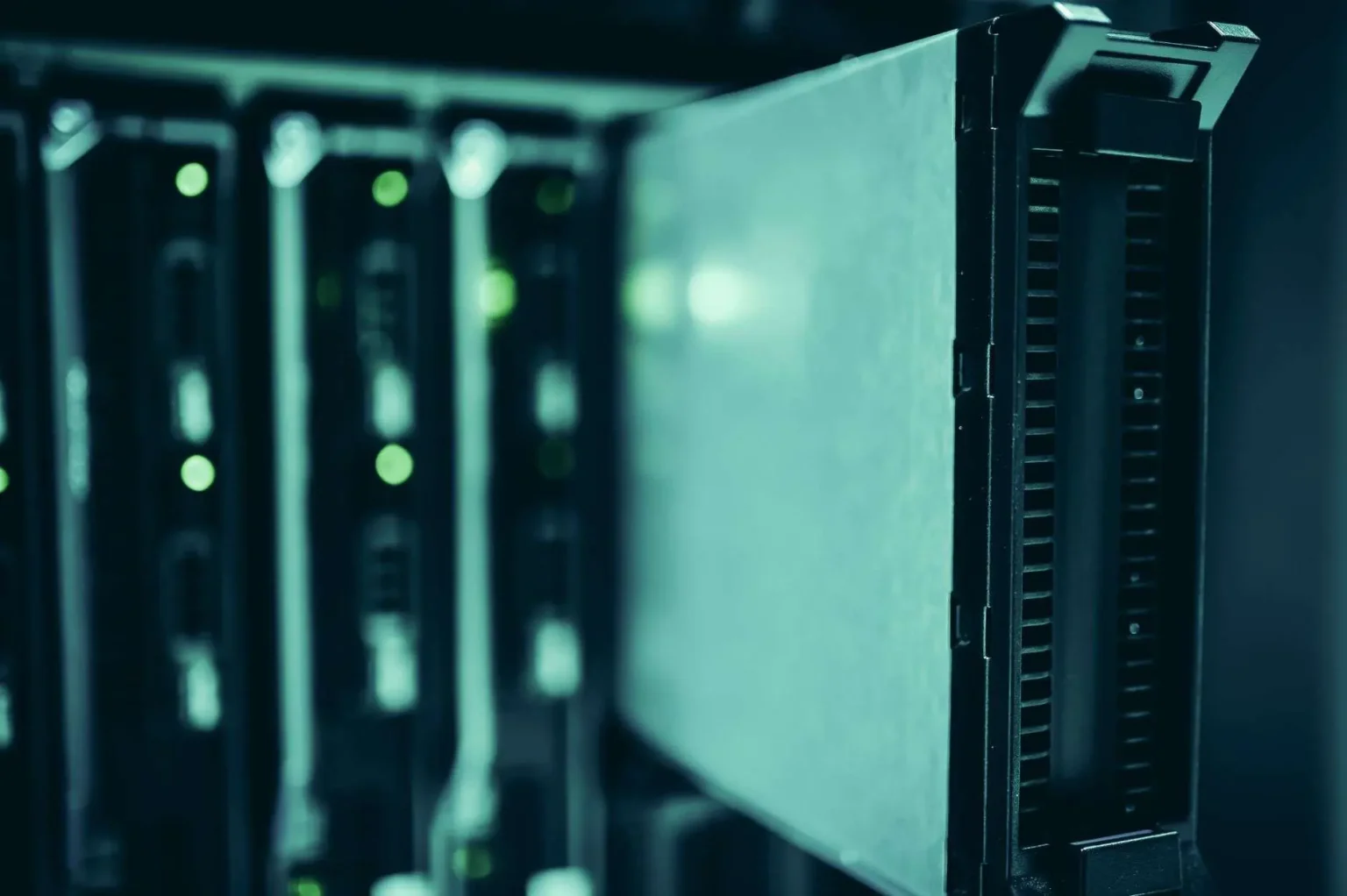 Rows of illuminated server racks inside a large data center facility